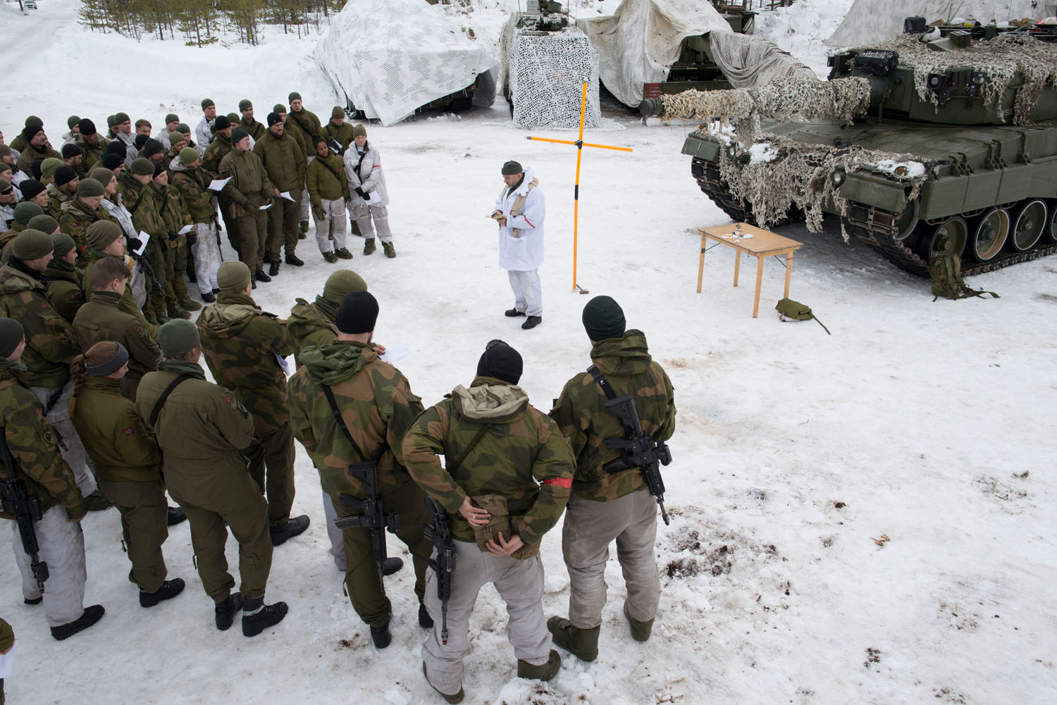 Norwegian soldiers are led in a prayer during joint exercises with Finland, Sweden, the United Kingdom, and the United States armed forces. Norrbotten, Sweden, March, 2019.