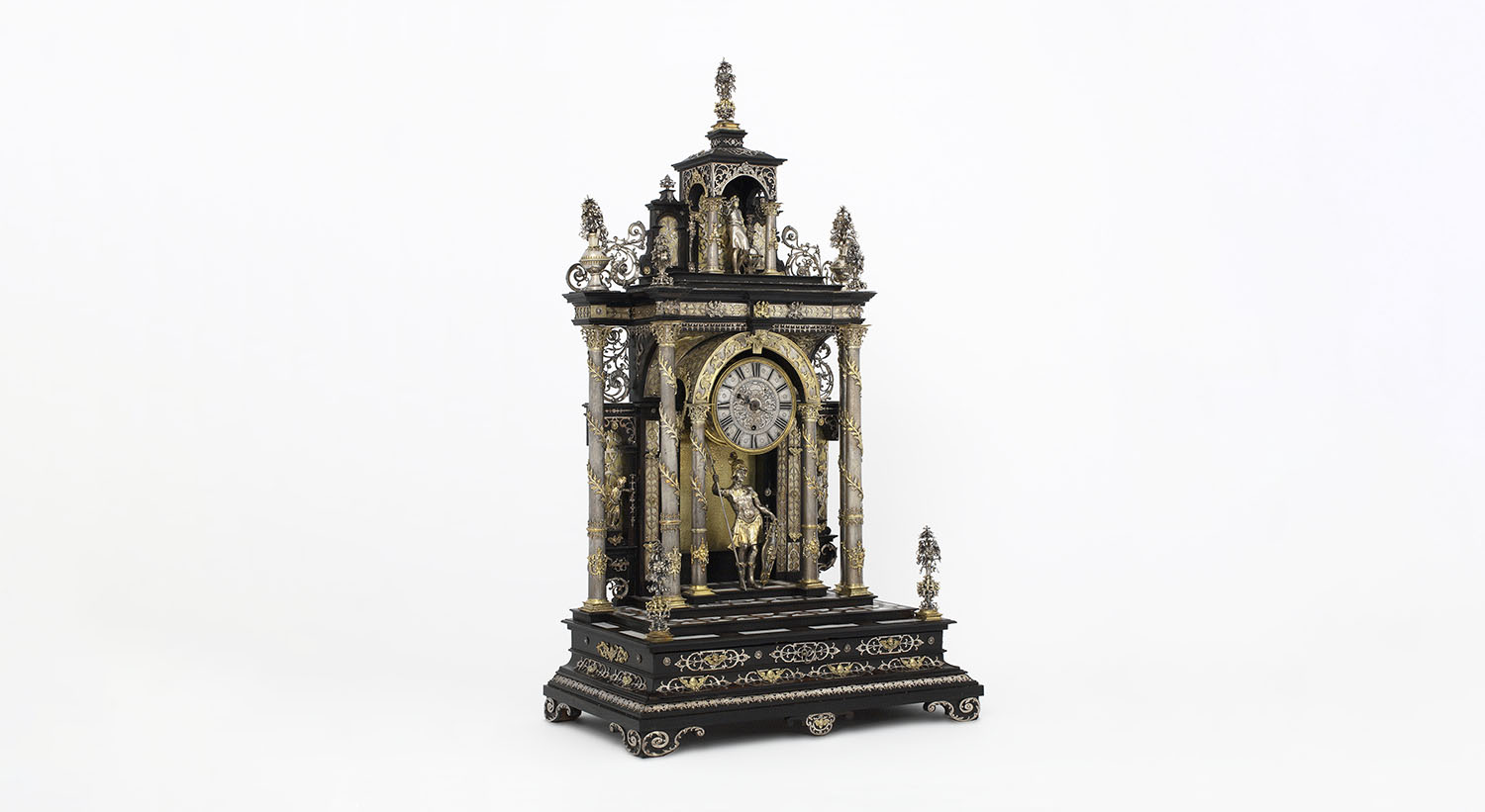 <p><b>Clock</b>, circa 1890<br>Makers: Elias Kreitmayer & Matthias Walbaum <br>Silver and gilded silver, ebonised wood, inlaid with mother-of-pearl and ivory, glass<br>(© The Rosalinde and Arthur Gilbert Collection on loan to the Victoria and Albert Museum. London.)</p>
