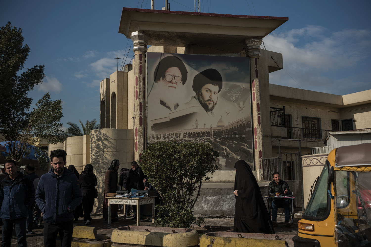 A billboard of Shia cleric Muqtada al-Sadr and his late father, Mohammed Sadeq al-Sadr, in Baghdad's largest slum, Sadr City. Muqtada al-Sadr was an early supporter of the protesters, but his position has been inconsistent; many speculate that his recent critiques of the movement are the result of Iranian financial backing.
