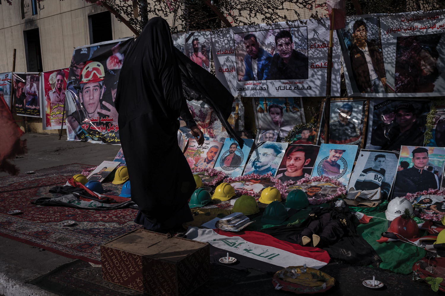 A woman offers prayers amid a makeshift shrine to those who've died during the protests.