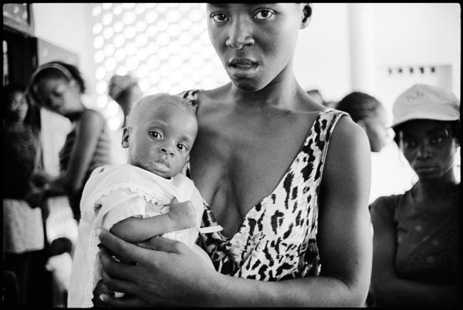 Marie Camel holds her eleven-month-old baby, Jacqueline, at the APROSIFA, Women's Shelter in the Carrefour Feuilles slum of Port-au-Prince. 